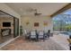 Covered outdoor patio with a dining table, ceiling fan, and access to both the pool and living room at 3921 Waypoint Ave, Osprey, FL 34229