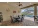 Relaxing outdoor patio with dining table, ceiling fan, and a view of the pool and screened-in backyard at 3921 Waypoint Ave, Osprey, FL 34229
