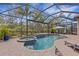 Screened pool area with lush landscaping, a spa, and lounge chairs create a relaxing outdoor oasis at 3921 Waypoint Ave, Osprey, FL 34229