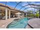 The in-ground pool features a spa and tanning ledge, with a covered patio providing shade for dining and lounging at 3921 Waypoint Ave, Osprey, FL 34229