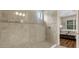 Modern tiled shower with glass door adjacent to bedroom at 3921 Waypoint Ave, Osprey, FL 34229