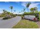 Elegant community entrance sign featuring lush landscaping, palm trees and a welcoming atmosphere at 3921 Waypoint Ave, Osprey, FL 34229