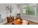 Comfortable sitting area with natural light, stylish decor, and wood-look flooring at 3921 Waypoint Ave, Osprey, FL 34229