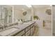 Spacious bathroom with dual sinks, granite counters, glass shower, and soaking tub at 3954 Wilshire Cir # 165, Sarasota, FL 34238