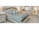 Bright bedroom featuring a queen-sized bed, and a dresser with a mirror at 3954 Wilshire Cir # 165, Sarasota, FL 34238