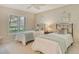 Inviting bedroom featuring twin beds, neutral walls and a large window with shutters at 3954 Wilshire Cir # 165, Sarasota, FL 34238