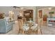 Cozy dining area with seating for four and view into the living room with large TV at 3954 Wilshire Cir # 165, Sarasota, FL 34238