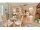 Cozy dining area features a glass table and seating for four with natural light at 3954 Wilshire Cir # 165, Sarasota, FL 34238