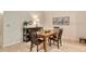 Traditional dining room with wood table and chairs, with a cabinet for storage at 3954 Wilshire Cir # 165, Sarasota, FL 34238