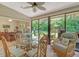Cozy breakfast nook with sliding glass doors and wicker chairs at 3954 Wilshire Cir # 165, Sarasota, FL 34238
