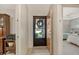 The foyer showcases the entrance to the main bedroom with neutral walls and tiled flooring at 3954 Wilshire Cir # 165, Sarasota, FL 34238