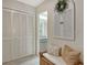 Hallway seating nook with view of the vanity and mirrored wall of the bathroom at 3954 Wilshire Cir # 165, Sarasota, FL 34238