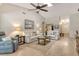 Bright living room with comfortable seating, neutral colors, and ceiling fan at 3954 Wilshire Cir # 165, Sarasota, FL 34238