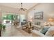 Bright living room with tile floors, access to lanai and comfortable seating at 3954 Wilshire Cir # 165, Sarasota, FL 34238