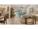 Open-concept living space with a kitchen, dining area, and living room featuring tiled floors and natural light at 3954 Wilshire Cir # 165, Sarasota, FL 34238