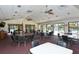 A recreational meeting room featuring tables, chairs, and sliding glass doors to the pool area at 3954 Wilshire Cir # 165, Sarasota, FL 34238