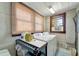 Laundry room with washer, dryer, storage, and window at 4030 Worcester Rd, Sarasota, FL 34231