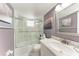 Cozy bathroom featuring marble countertops and shower over tub with glass doors at 4040 Ironwood Cir # 401F, Bradenton, FL 34209