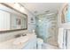 Elegant bathroom featuring marble countertops and walk-in shower with glass doors at 4040 Ironwood Cir # 401F, Bradenton, FL 34209