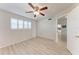 Empty bedroom with a ceiling fan, plantation shutters, and a door to another room at 4040 Ironwood Cir # 401F, Bradenton, FL 34209