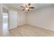 Empty bedroom with a ceiling fan, closet, and door leading to another room at 4040 Ironwood Cir # 401F, Bradenton, FL 34209