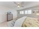 Bedroom featuring a ceiling fan, neutral walls, a chest-of-drawers, and plantation shutters at 4040 Ironwood Cir # 401F, Bradenton, FL 34209