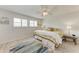 Light and airy bedroom features neutral walls, ceiling fan, and shuttered windows at 4040 Ironwood Cir # 401F, Bradenton, FL 34209