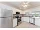 Bright kitchen featuring stainless steel appliances, granite countertops, and white cabinetry at 4040 Ironwood Cir # 401F, Bradenton, FL 34209