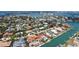 Aerial view showcases the home's backyard pool, waterfront access, complemented by lush landscaping and surrounding upscale properties at 465 E Royal Flamingo Dr, Sarasota, FL 34236