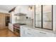 Modern kitchen with stainless steel appliances, a wine cooler, designer cabinets, and marble countertops at 465 E Royal Flamingo Dr, Sarasota, FL 34236