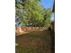 Fenced backyard has grassy area, mature trees, and a privacy wall at 4707 1St E Ave # 4707, Palmetto, FL 34221
