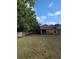 Large backyard featuring lush greenery and a screened-in porch at 4707 1St E Ave # 4707, Palmetto, FL 34221