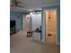 Comfortable bedroom adjacent to bathroom and closet with neutral carpet and light blue walls at 4707 1St E Ave # 4707, Palmetto, FL 34221