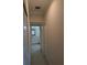 Hallway with storage closets leading to a bright bathroom with a vanity at 4707 1St E Ave # 4707, Palmetto, FL 34221