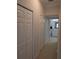 Hallway with storage closet and bathroom view, carpet floor, and neutral walls at 4707 1St E Ave # 4707, Palmetto, FL 34221