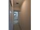 Hallway with storage closets leading to a bright bathroom with a vanity at 4707 1St E Ave # 4707, Palmetto, FL 34221