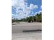 Neighborhood street view of the gated entrance to this beautiful community under a sunny sky at 4707 1St E Ave # 4707, Palmetto, FL 34221
