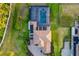 Drone shot of tile roof of home with screened in pool, manicured landscaping, and patio at 4712 Margutta Ct, Sarasota, FL 34240