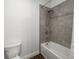 Modern bathroom with a bathtub and shower featuring neutral tile and sleek fixtures at 4712 Margutta Ct, Sarasota, FL 34240