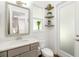 Bright bathroom with white marble countertop, grey vanity and decoratively shelved wall at 4712 Margutta Ct, Sarasota, FL 34240