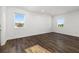 Spacious bedroom with hardwood flooring, abundant natural light, and white trim at 4712 Margutta Ct, Sarasota, FL 34240