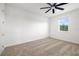 Clean and bright bedroom with neutral carpet, a ceiling fan, and a view from the window at 4712 Margutta Ct, Sarasota, FL 34240