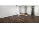 Bedroom features hardwood flooring, white trim, and a barn door leading to an en suite bathroom at 4712 Margutta Ct, Sarasota, FL 34240