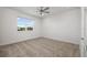 Clean and bright bedroom with a ceiling fan, neutral carpet, and a view from the window at 4712 Margutta Ct, Sarasota, FL 34240