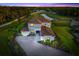 Stunning home with beautiful tile roof, lush landscaping, brick paver driveway, and pond view at 4712 Margutta Ct, Sarasota, FL 34240