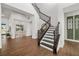 Grand foyer featuring an elegant staircase with iron railing, wood floors and an open floor plan at 4712 Margutta Ct, Sarasota, FL 34240