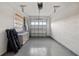 View of the empty garage with painted floors and walls, shelving, and a garage door at 4712 Margutta Ct, Sarasota, FL 34240