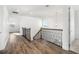Bright hallway with hardwood floors, wrought iron staircase, and natural light at 4712 Margutta Ct, Sarasota, FL 34240