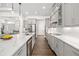 Bright, updated kitchen with stainless appliances, marble countertops and sleek gray cabinetry and wood-look tile floors at 4712 Margutta Ct, Sarasota, FL 34240