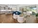 Open-concept living room with access to pool, contemporary furnishings, neutral paint, and modern lighting at 4712 Margutta Ct, Sarasota, FL 34240